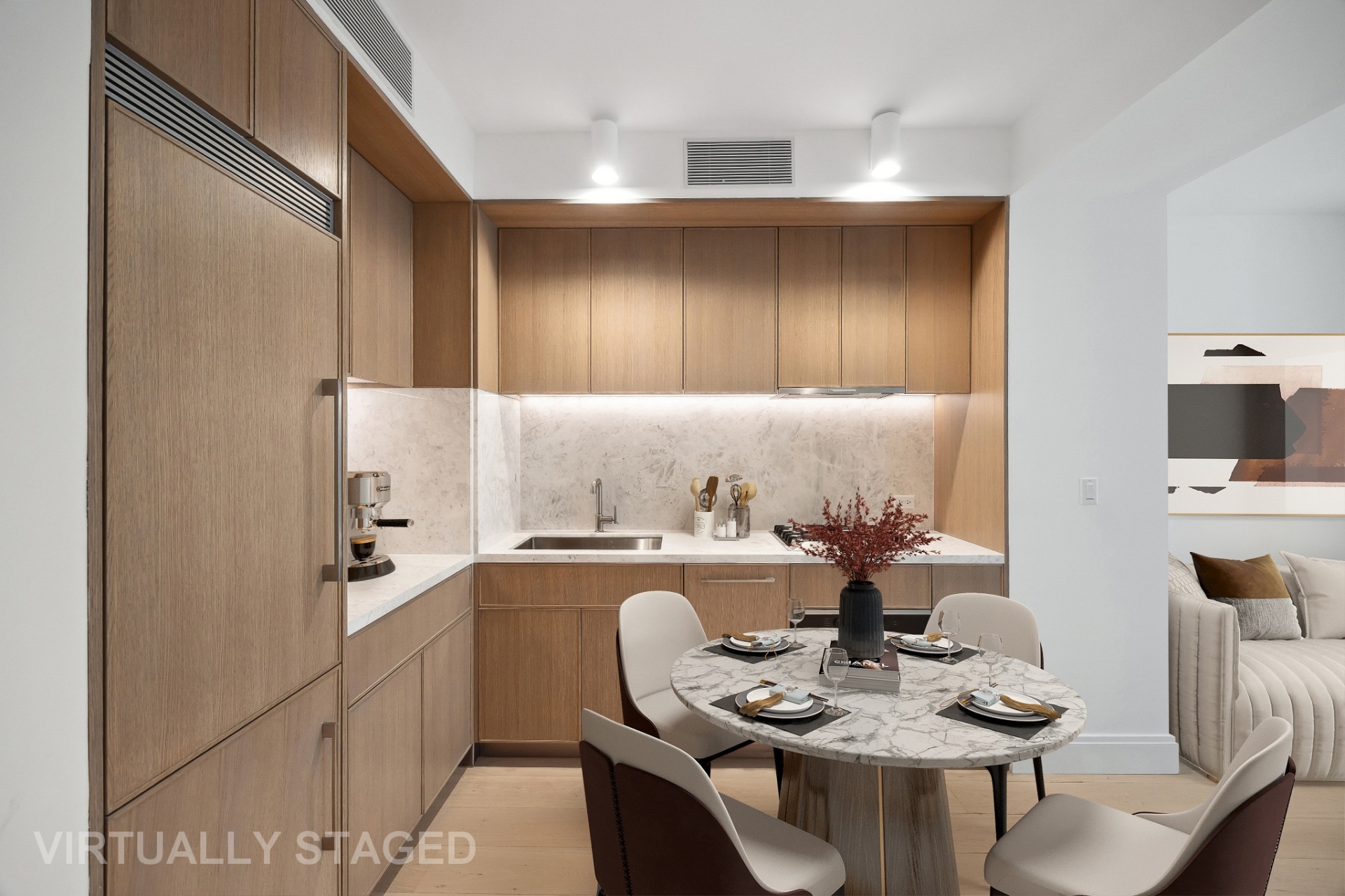 Custom oak kitchen with white marble countertops and integrated Miele appliances