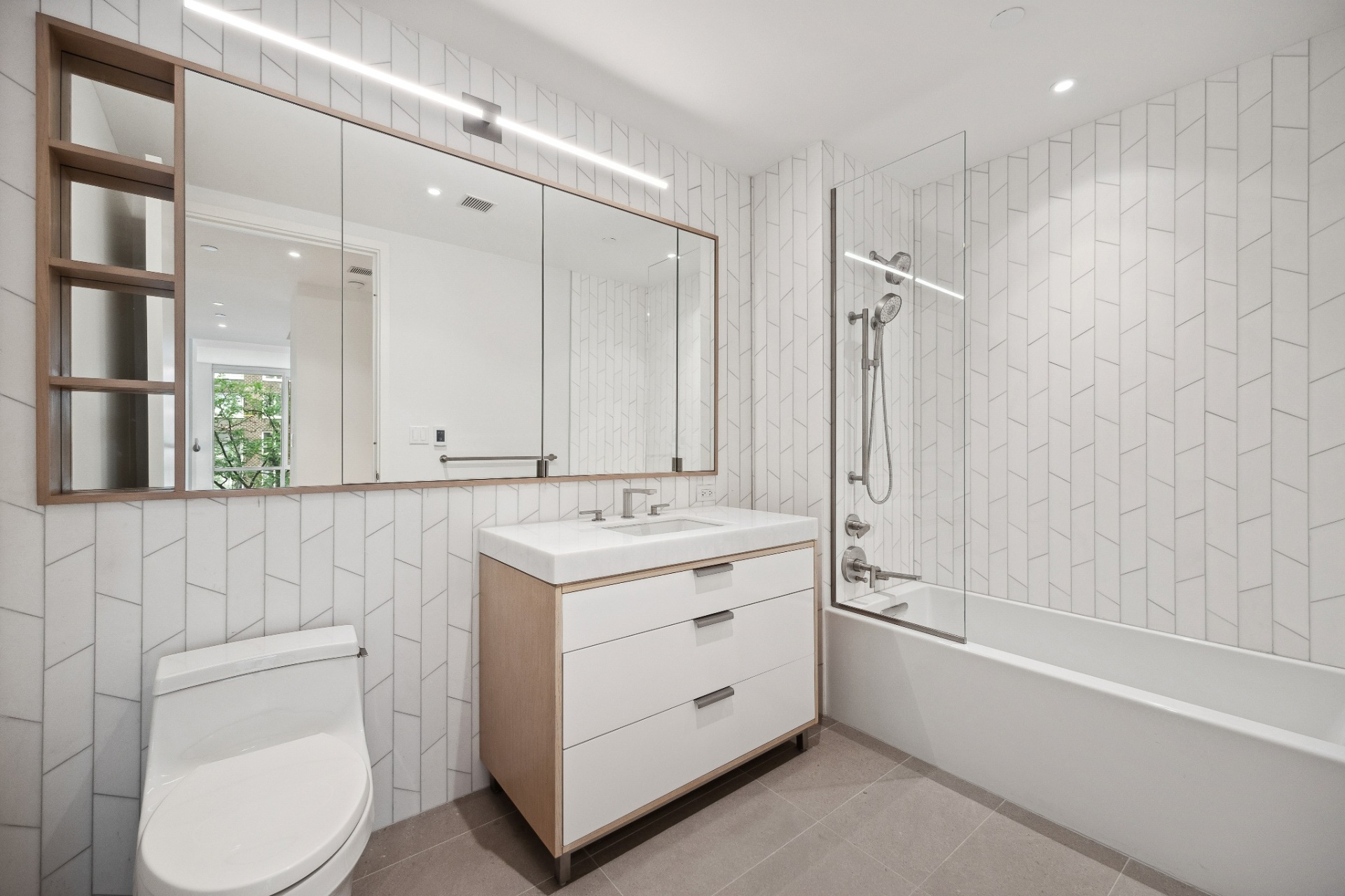 Bathroom with honed Dream White marble walls, Cinderella Grey marble floors, and Kohler soaking tub